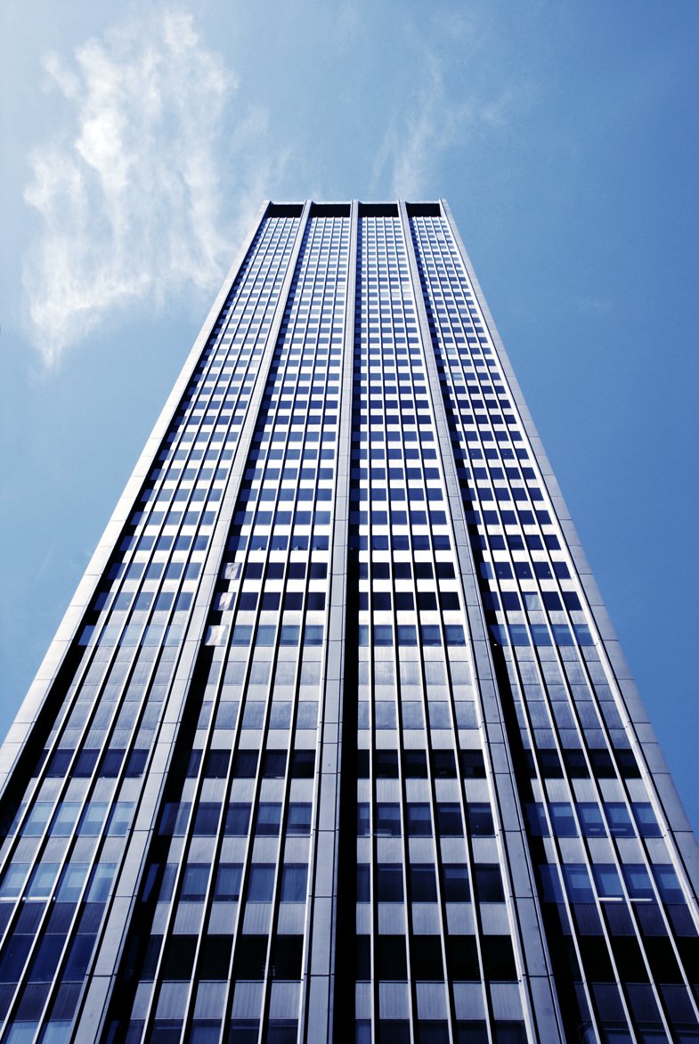 a large tall building towering above a city