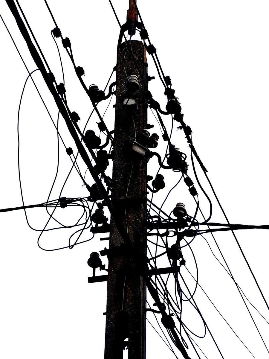 an electric pole with many wires and plugs attached