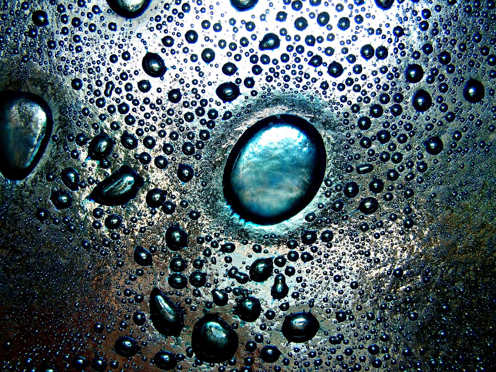 water drops with small bubbles floating down it