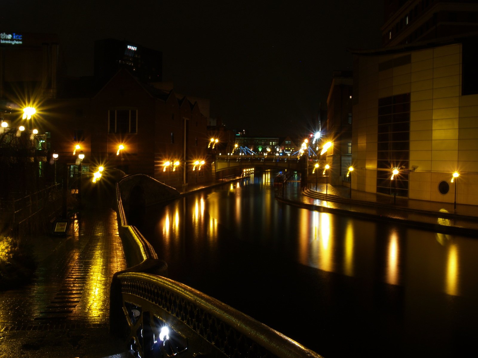lights shine brightly over the river at night
