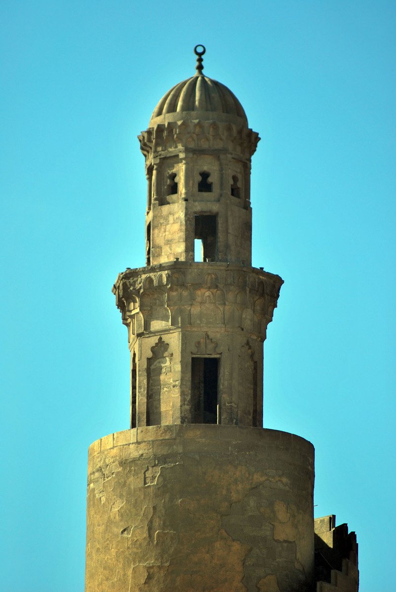 a building with a bell tower against the blue sky