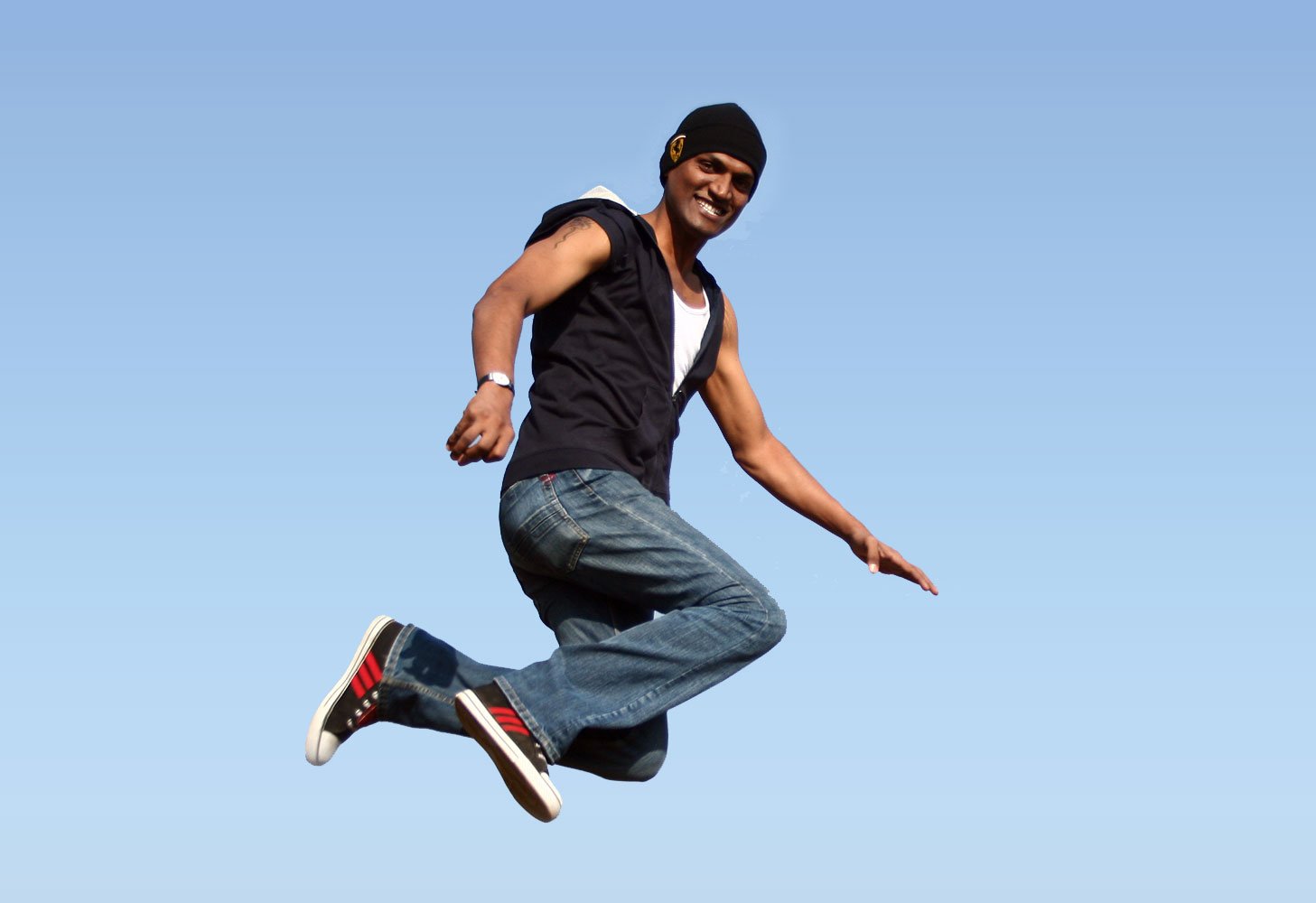 a man with a black shirt is jumping into the air