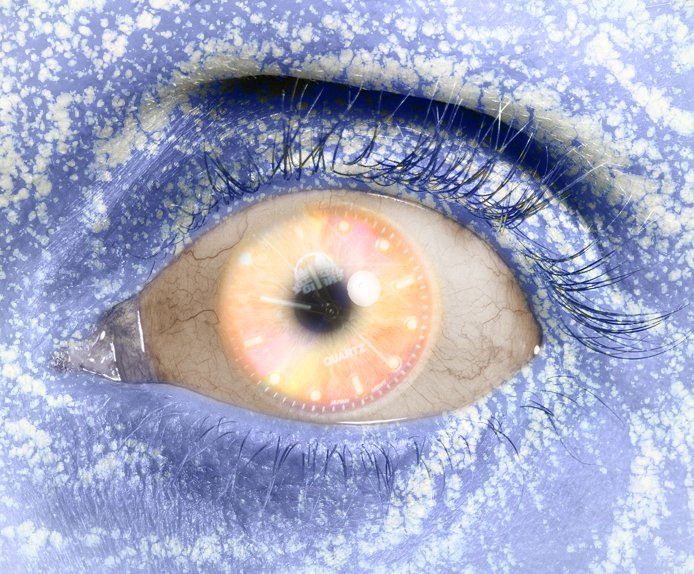 a close up of an eye that has some blue and white things on it