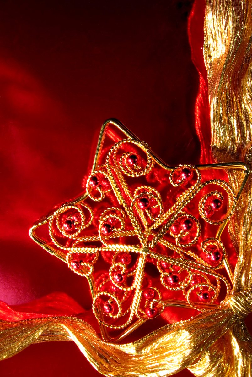 this is a gold decorative brooch designed with jewels