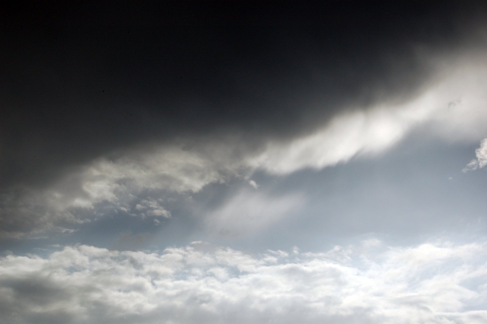 two planes fly through an almost cloudy sky