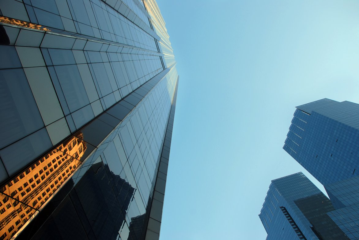 two very tall buildings with windows in the middle