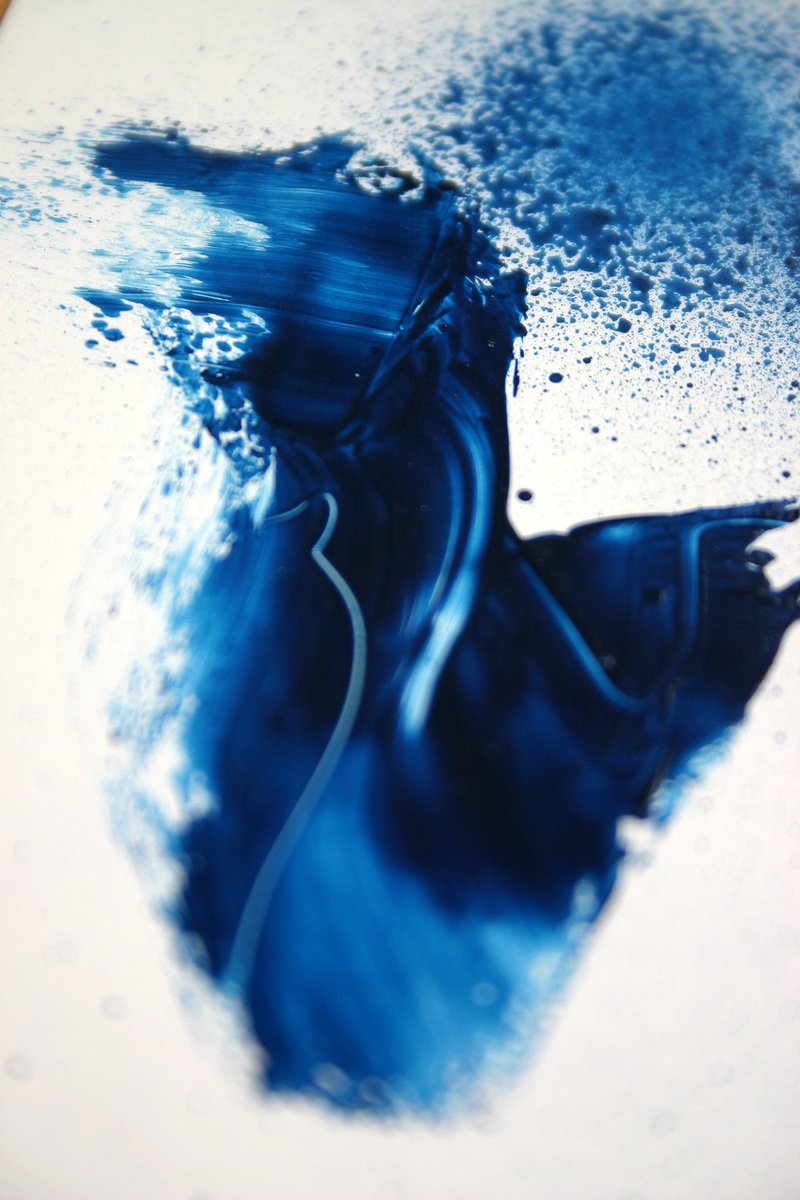 a dle of blue liquid being washed onto the ground
