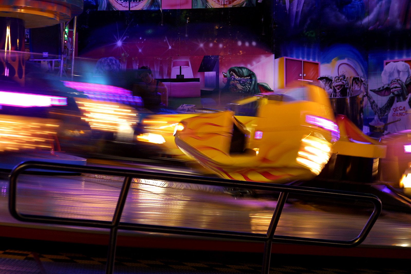 an amut rides on a ride with several cars behind it