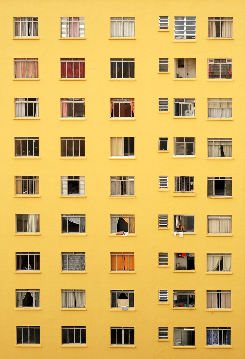 an orange building with many windows that are all over the place