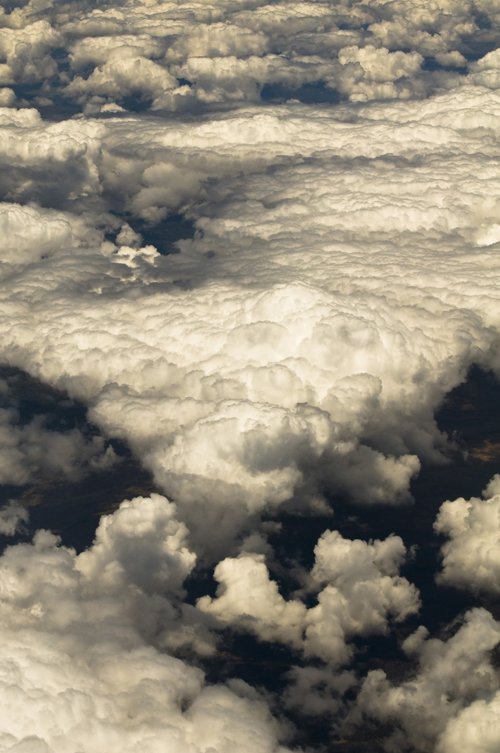 a view from a window seat of some white clouds