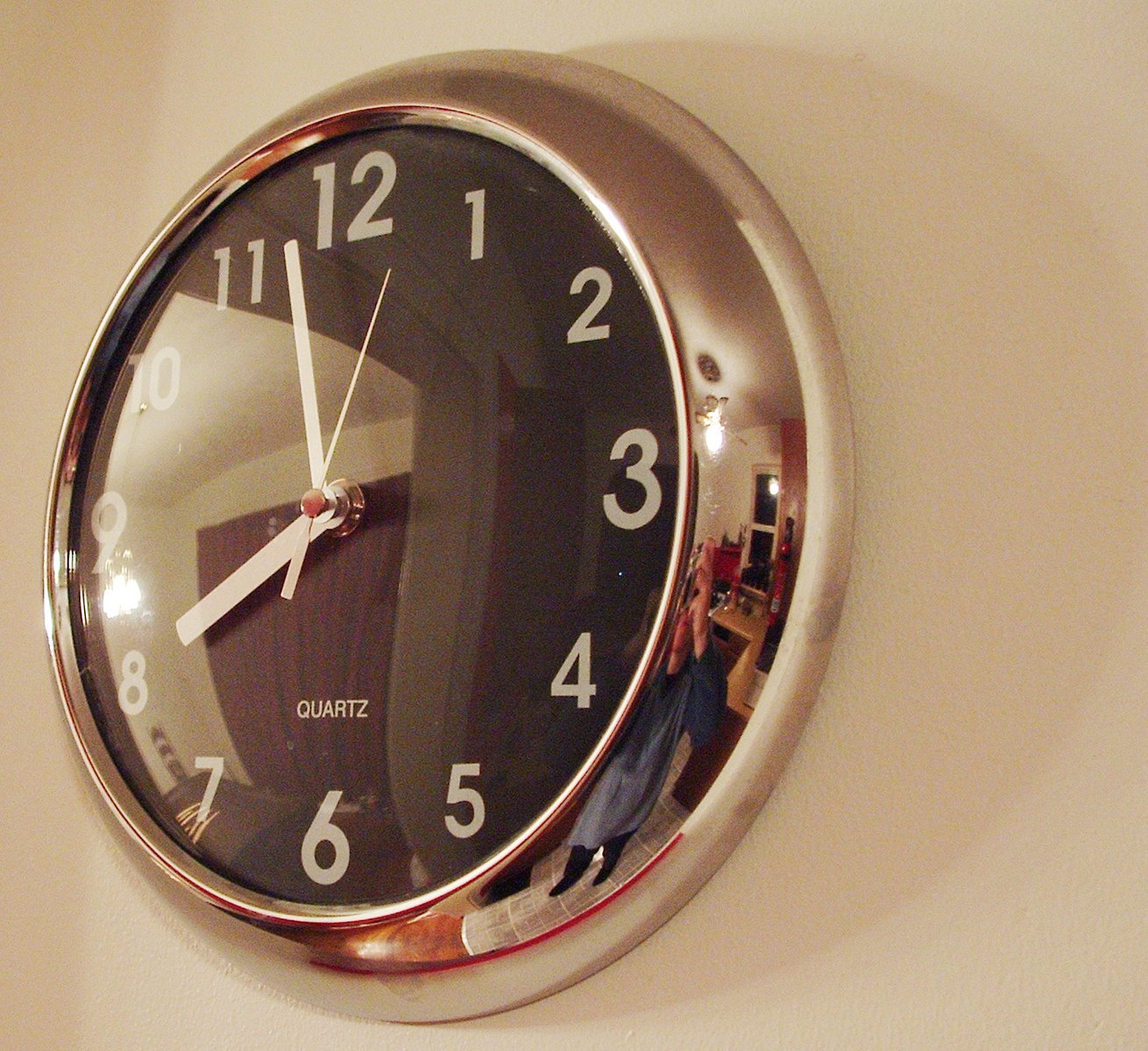 a large silver clock with numbers on the face