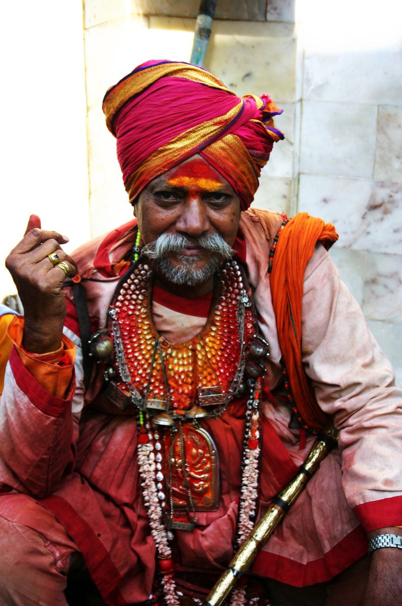 an old man sitting in a doorway smoking a cigarette