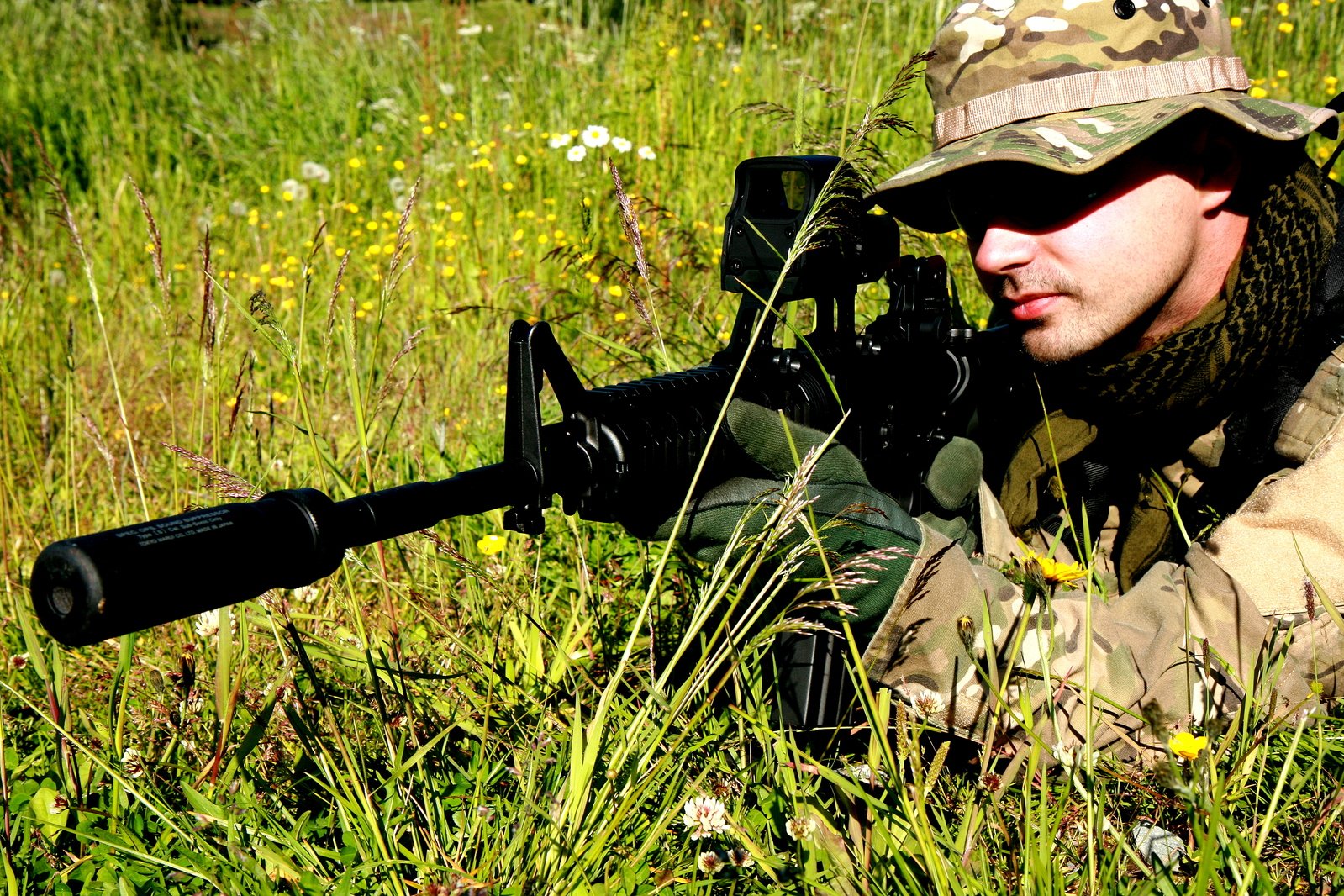 a soldier is posing for the camera in a grassy field