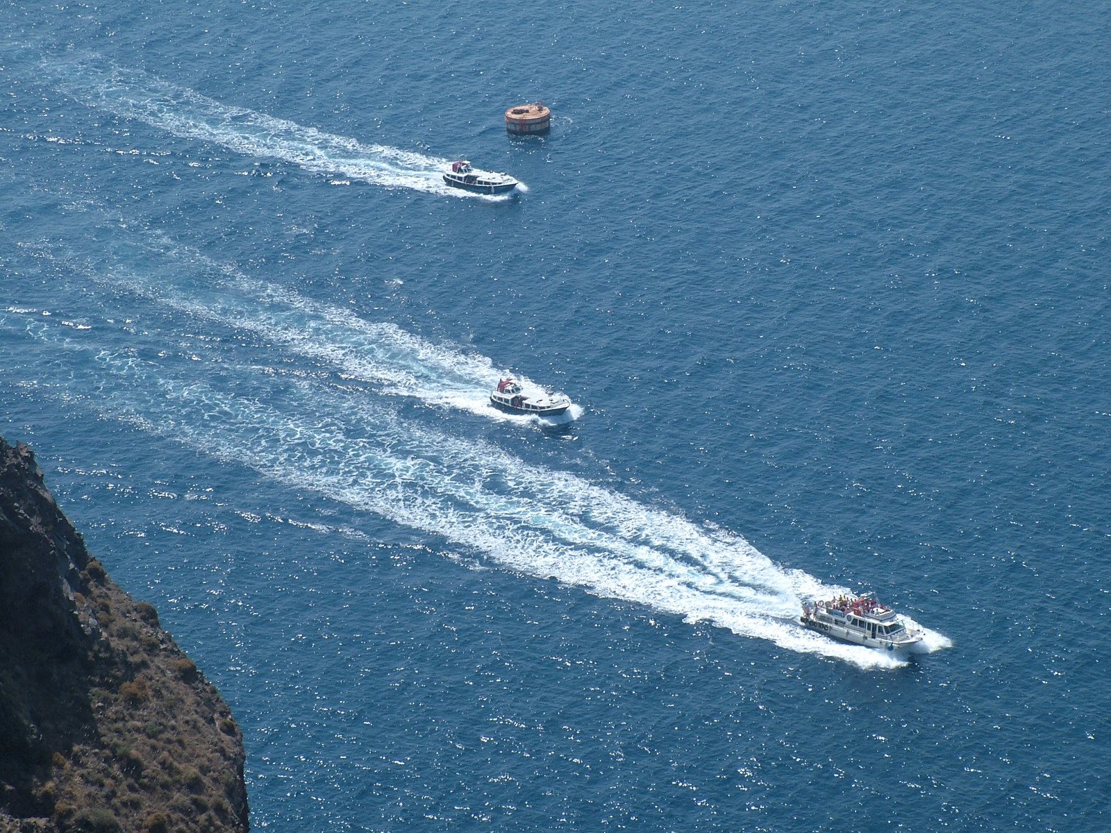 two small boats sailing in the open blue water