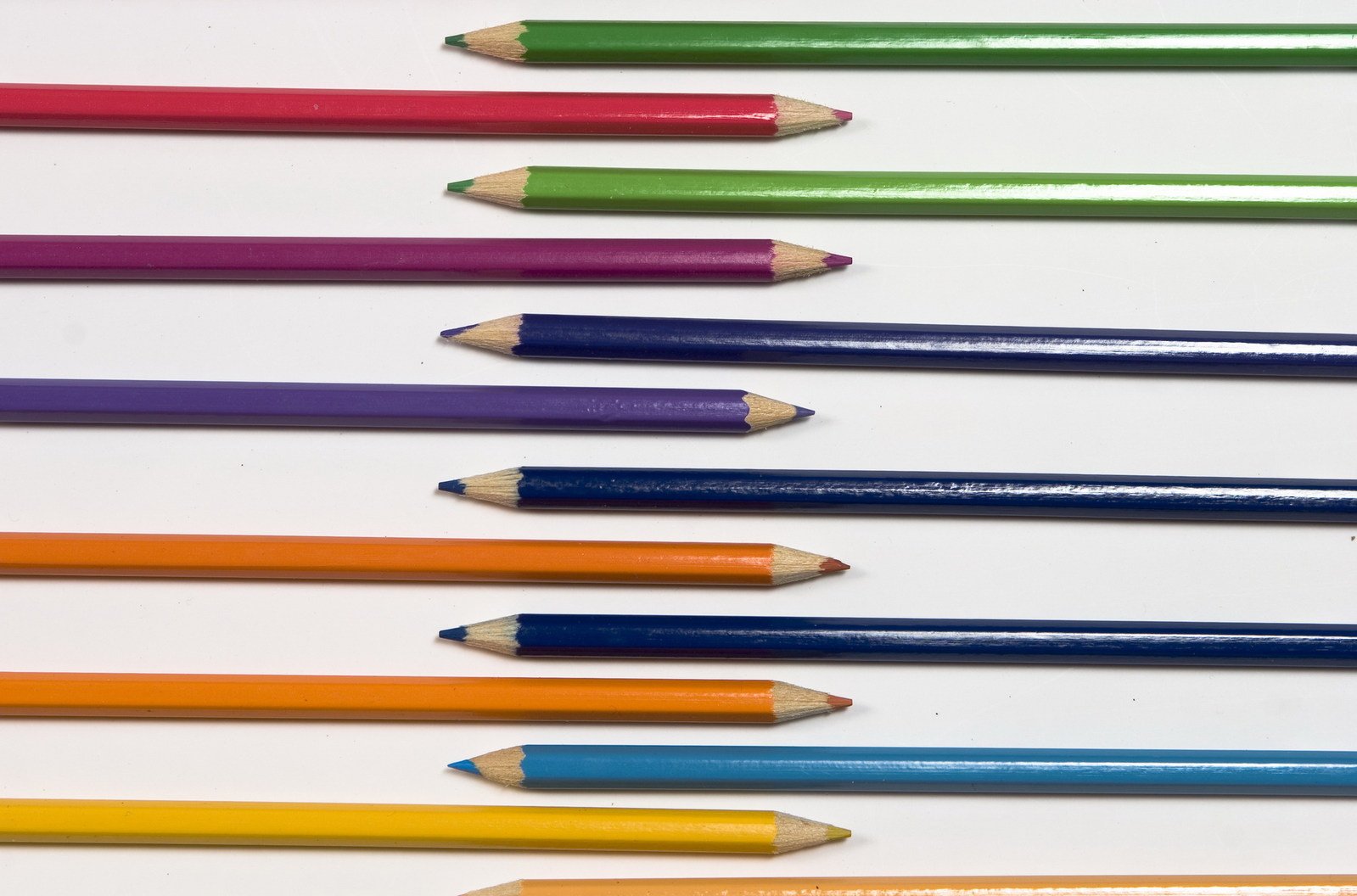 many pencils lined up together next to each other