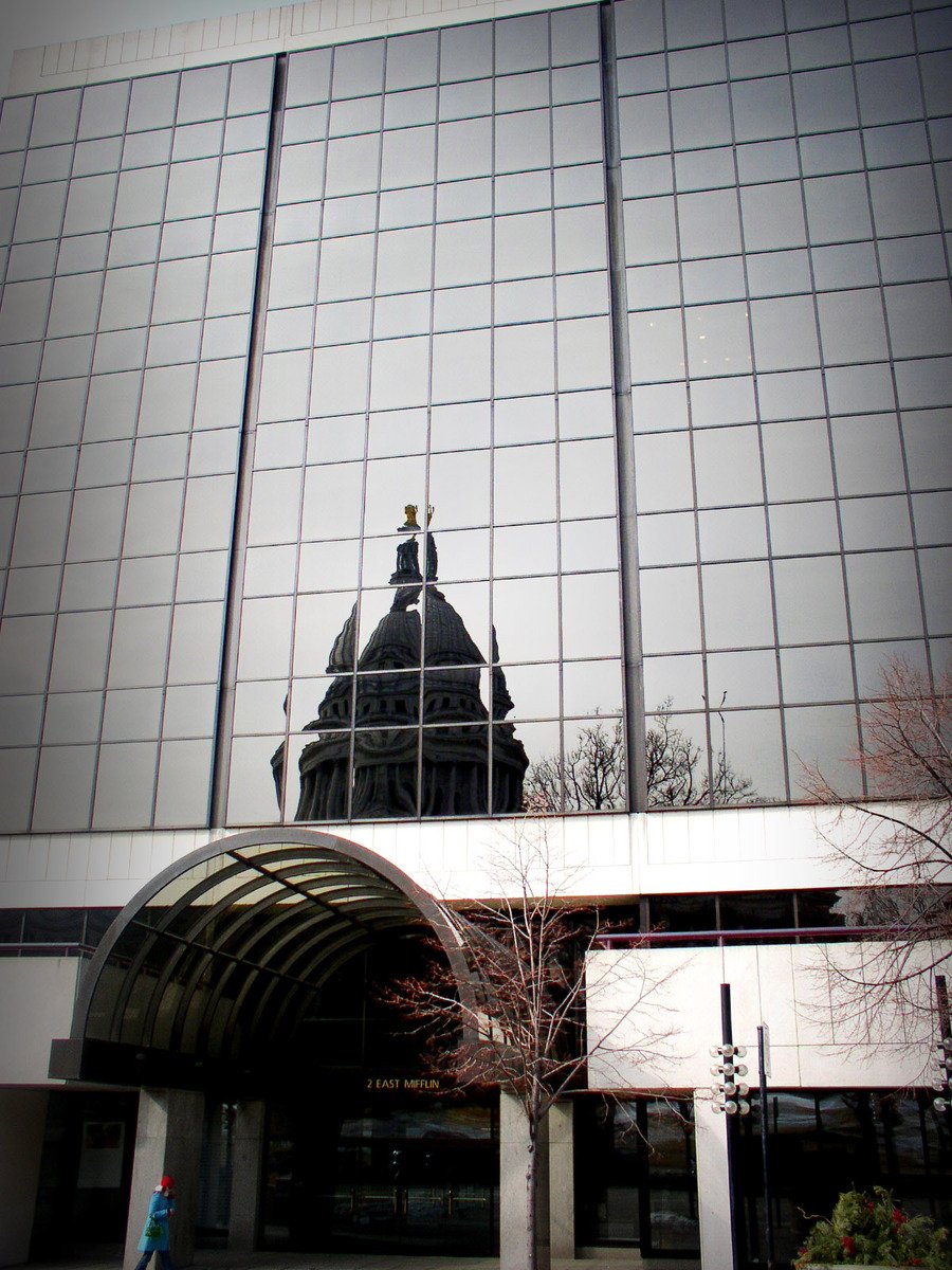 a large glass building with a clock tower