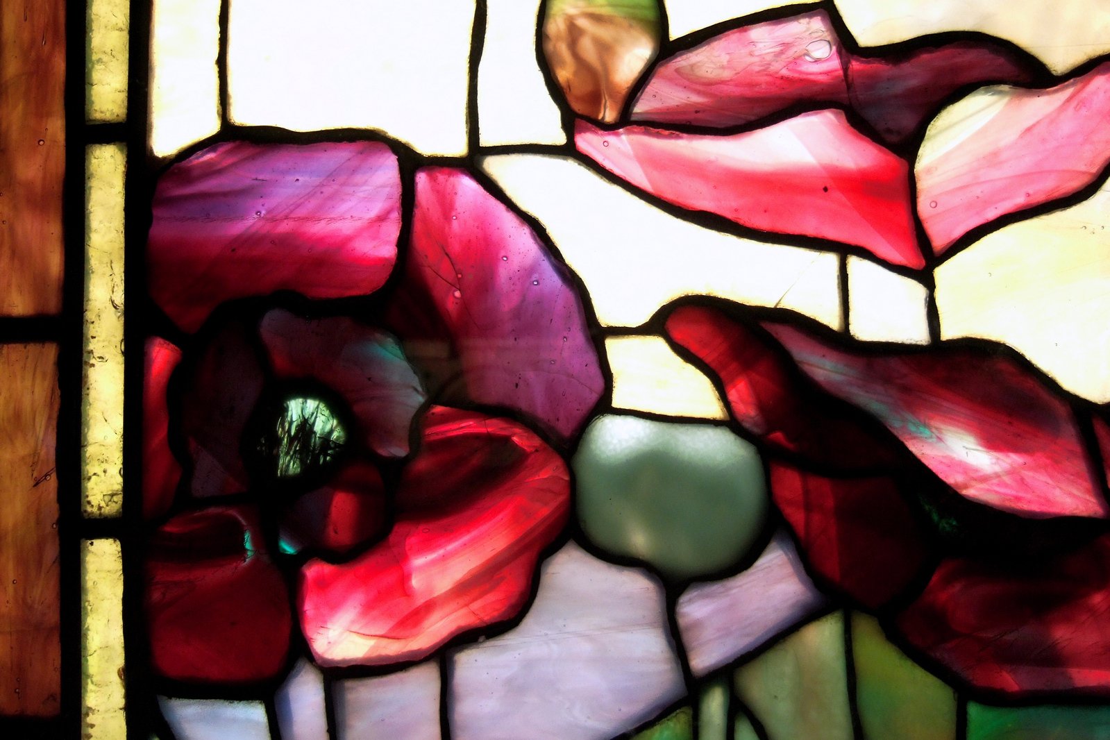 the large flower is depicted in this stained glass