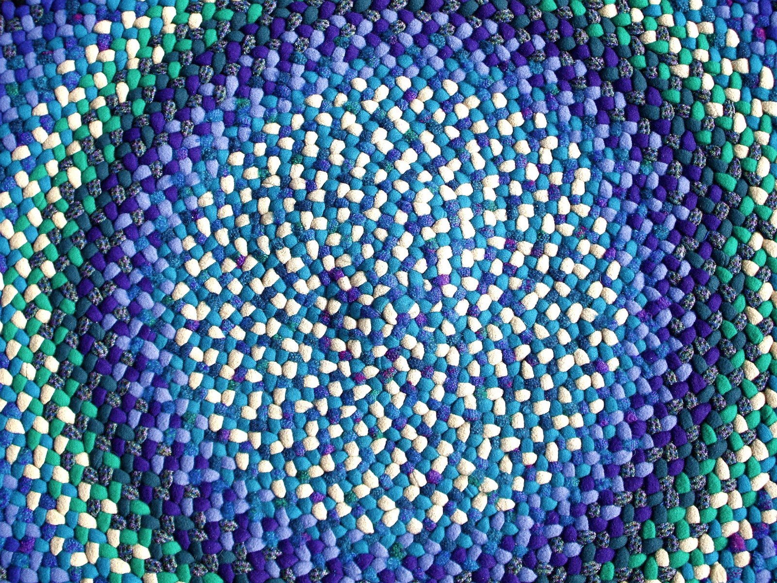 a circular pattern made out of several different color blue dots