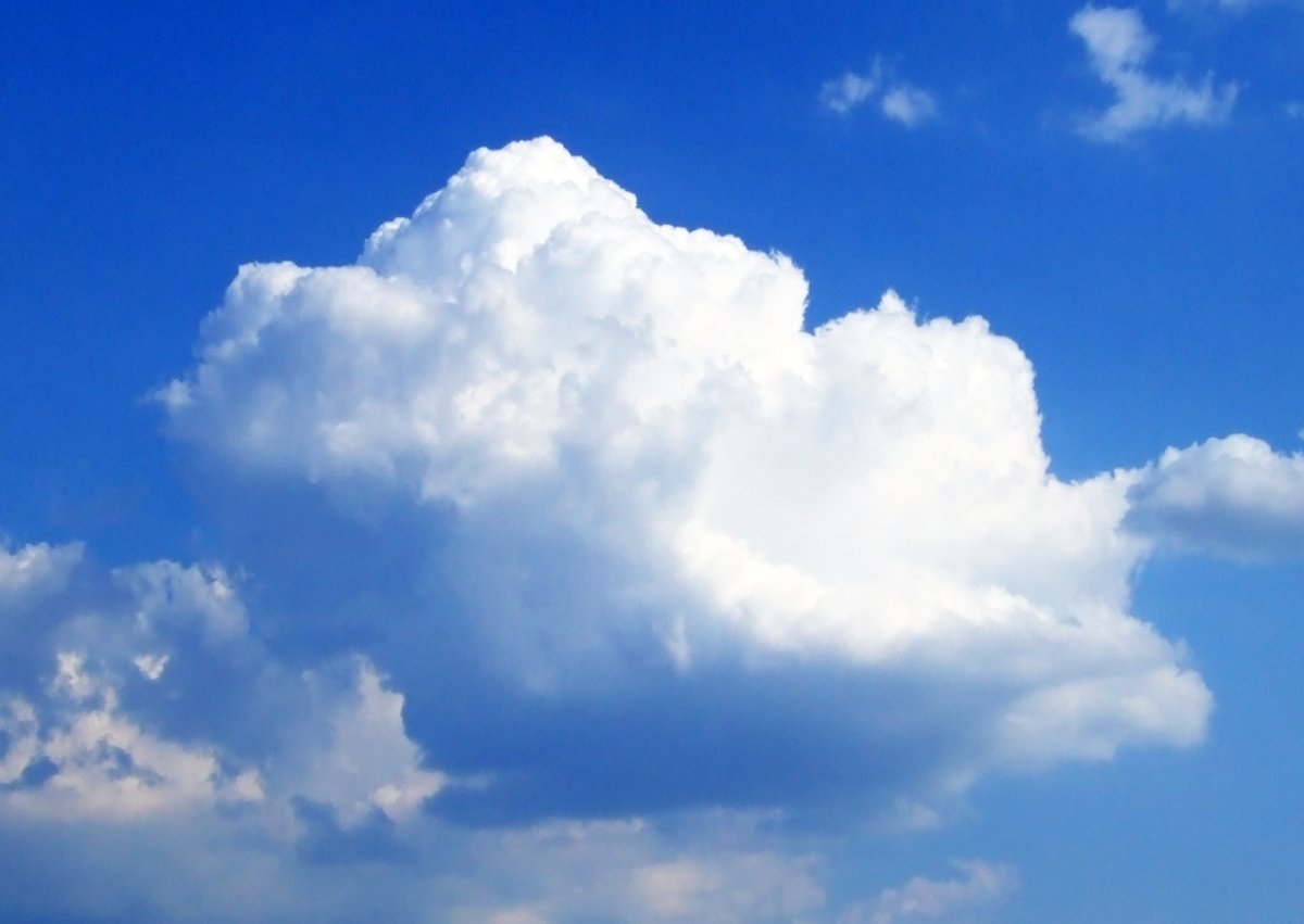 a white cloud floats in the blue sky