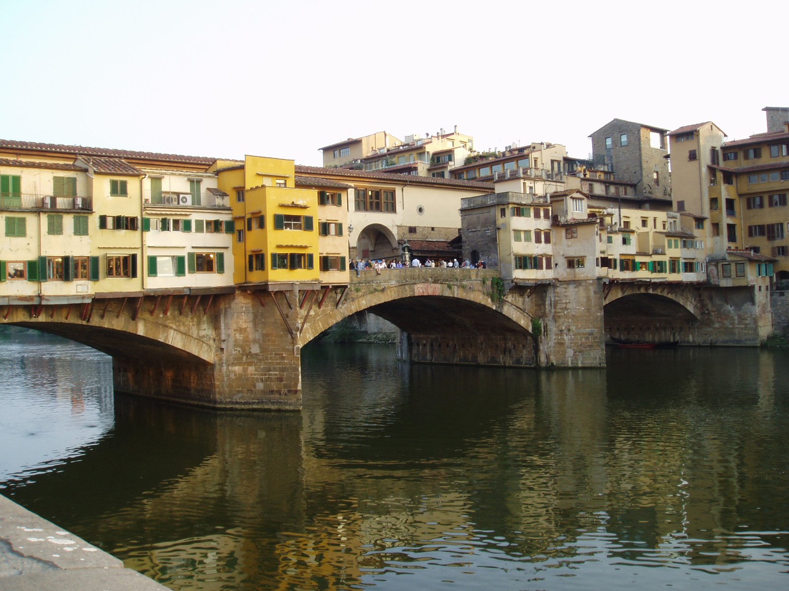 a bridge with old buildings near water