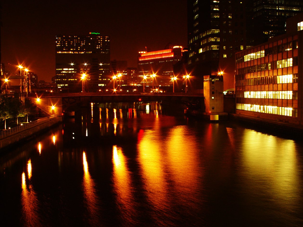 a river running through a city next to tall buildings