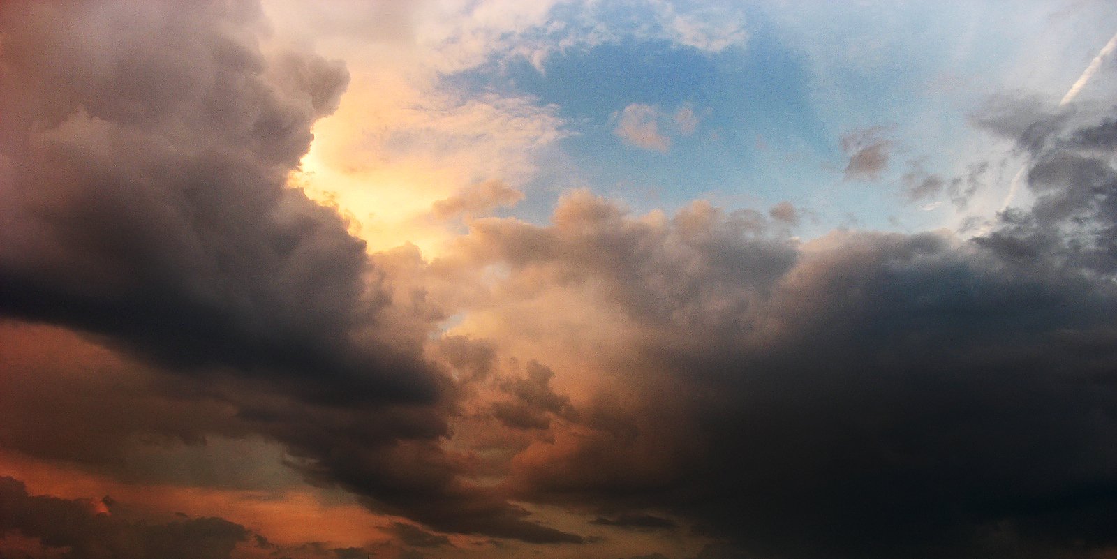 a sky with several different types of clouds above it