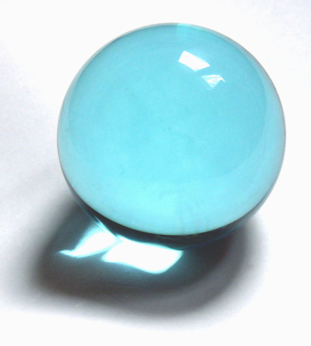 light blue ball sitting on top of a table