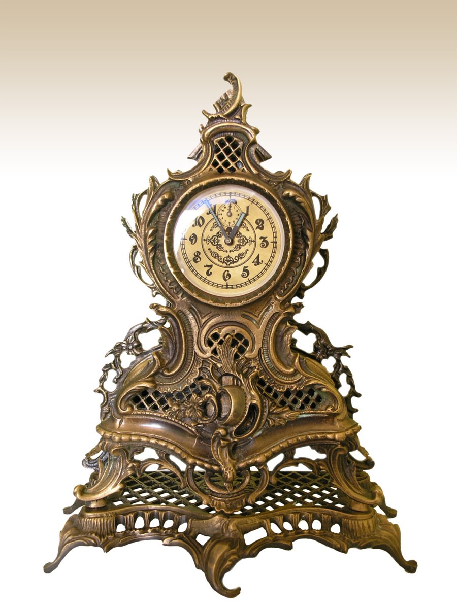 an ornate clock on a stand with some fancy decorations