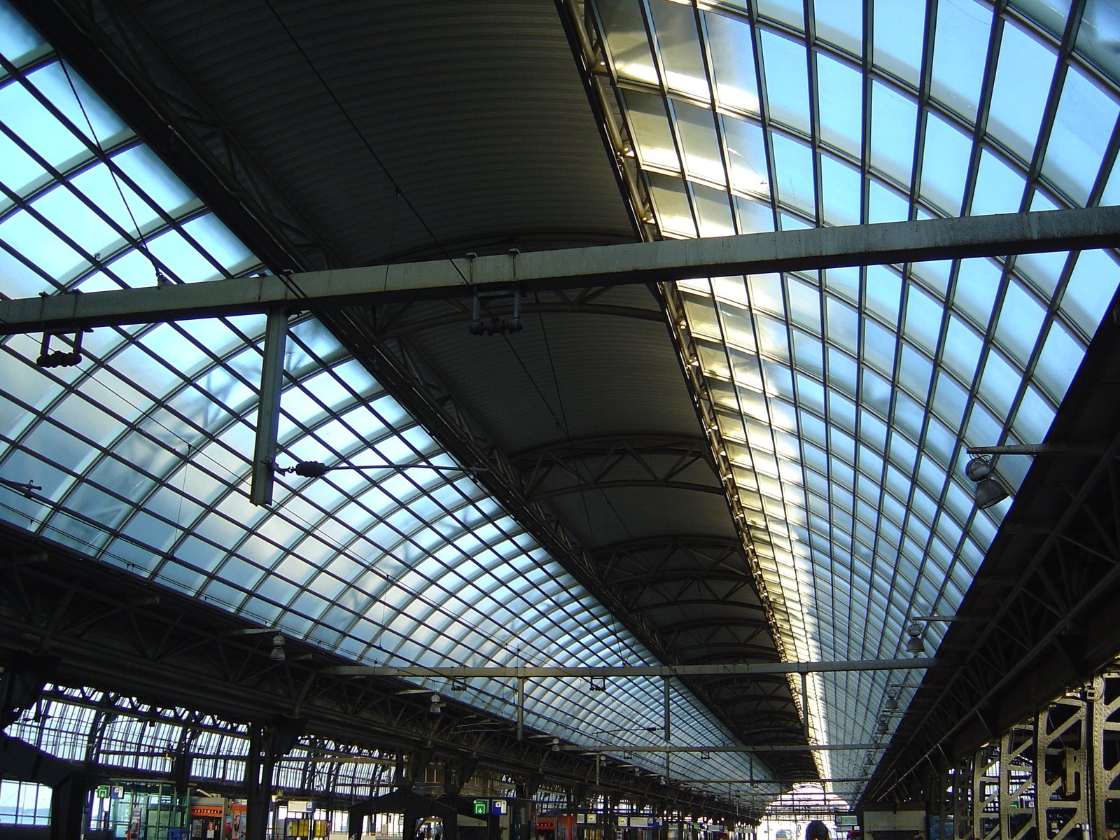 an empty, long train station with many platforms