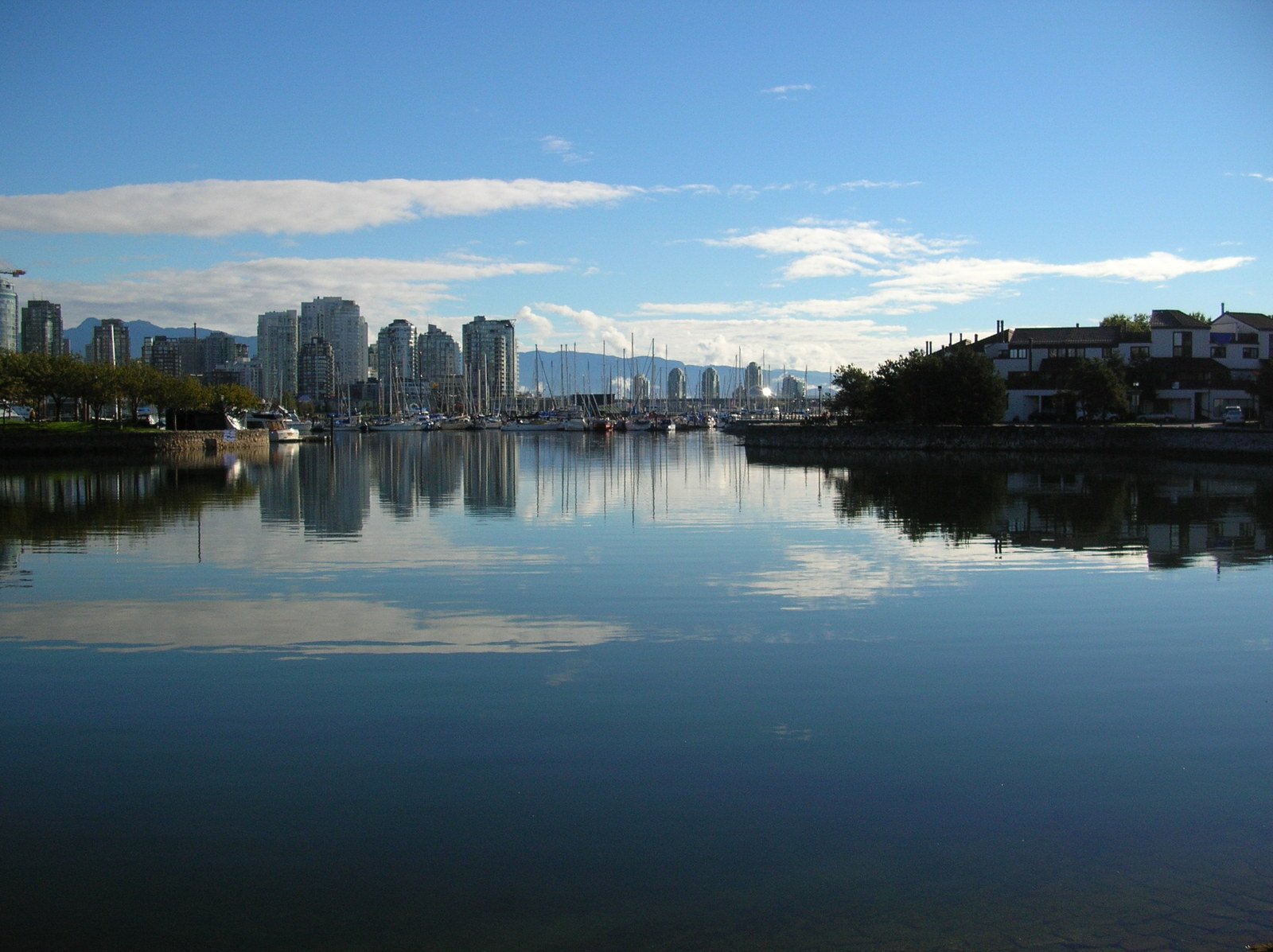 a harbor in front of buildings with lots of water