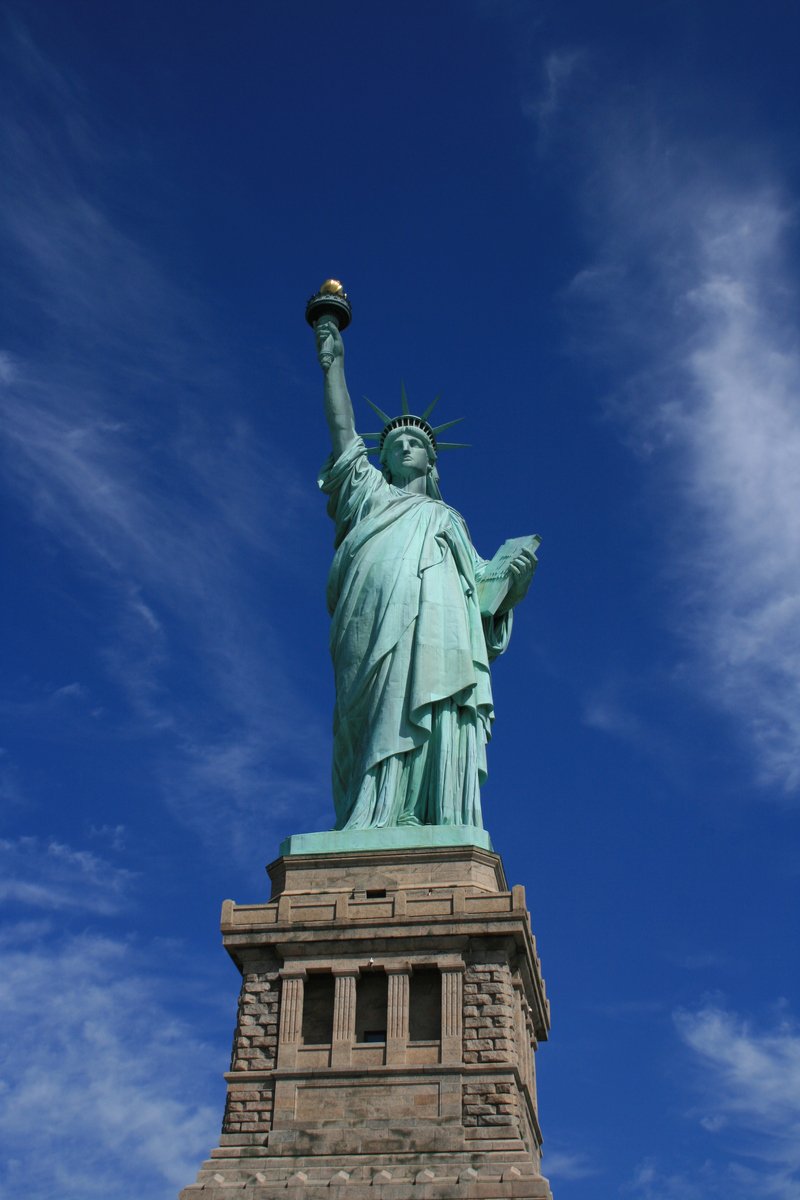 a tall statue with a lit lamp on top