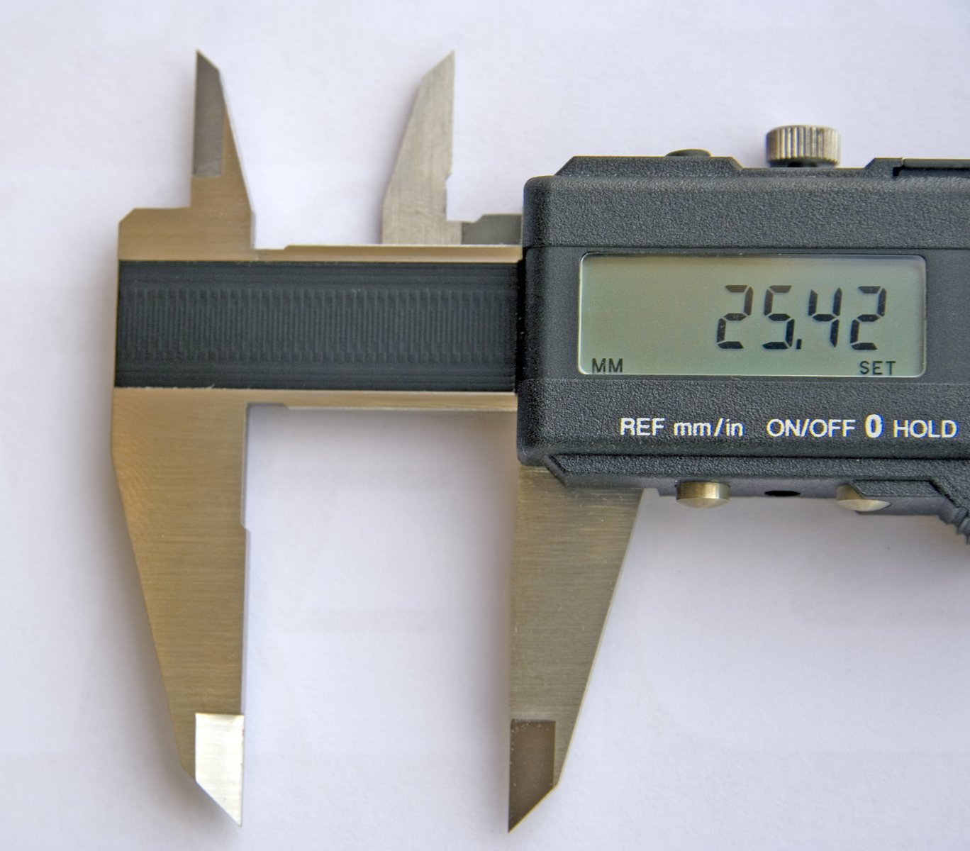 a caliper with some tools on it that read half - way