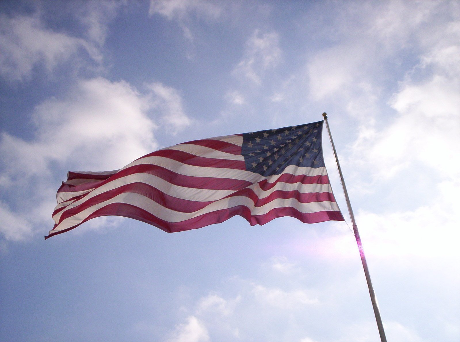 a large flag that is flying high in the sky