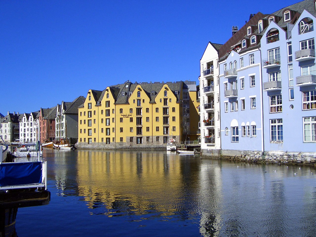 an image of several buildings by the water