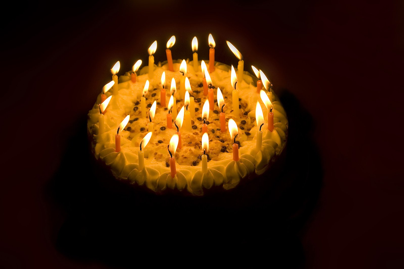 a group of lit candles with small candles on it