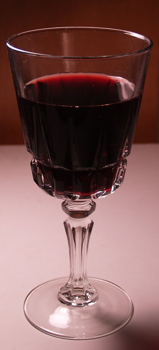 a glass of wine sits on a countertop