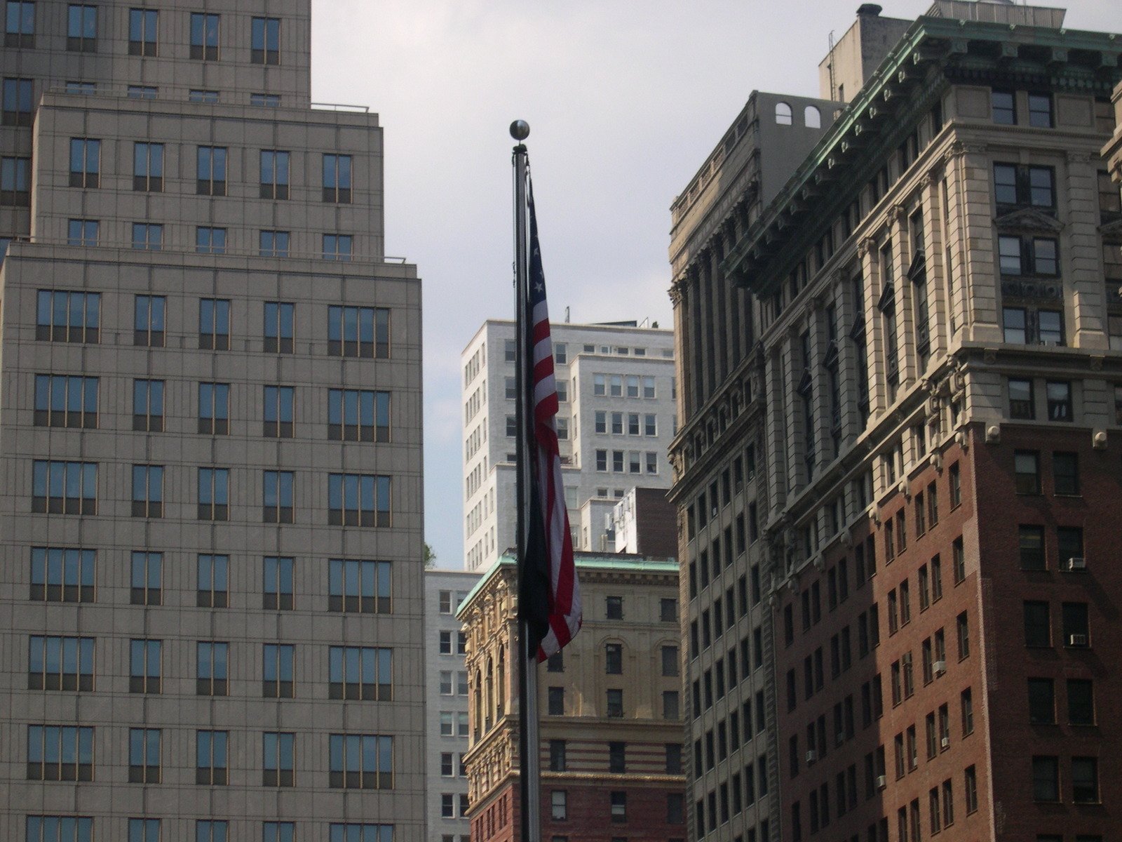there is a large american flag flying high in the city
