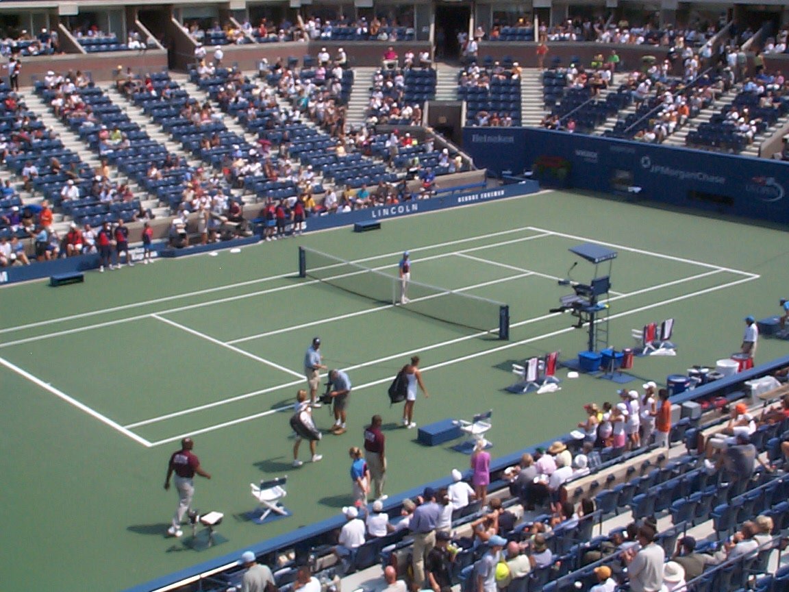an overhead view of two tennis players standing on the court