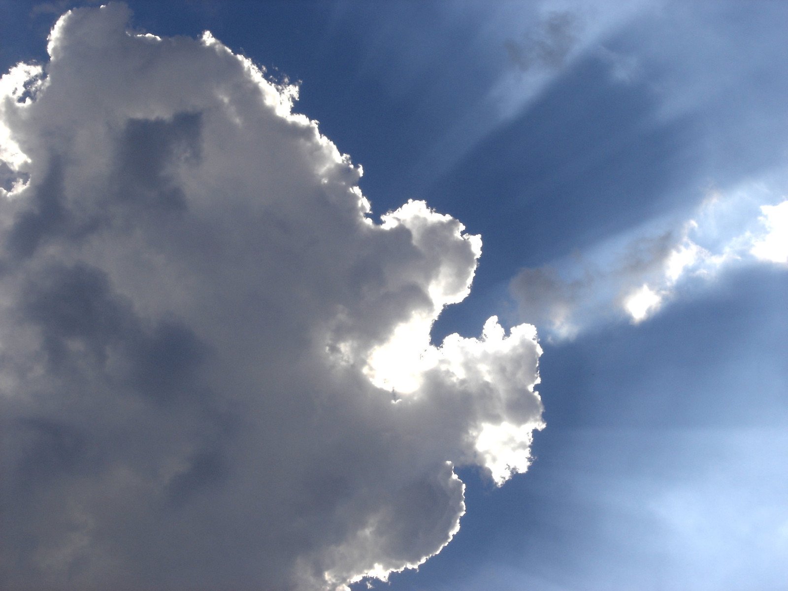 an airplane is flying through the clouds in the daytime