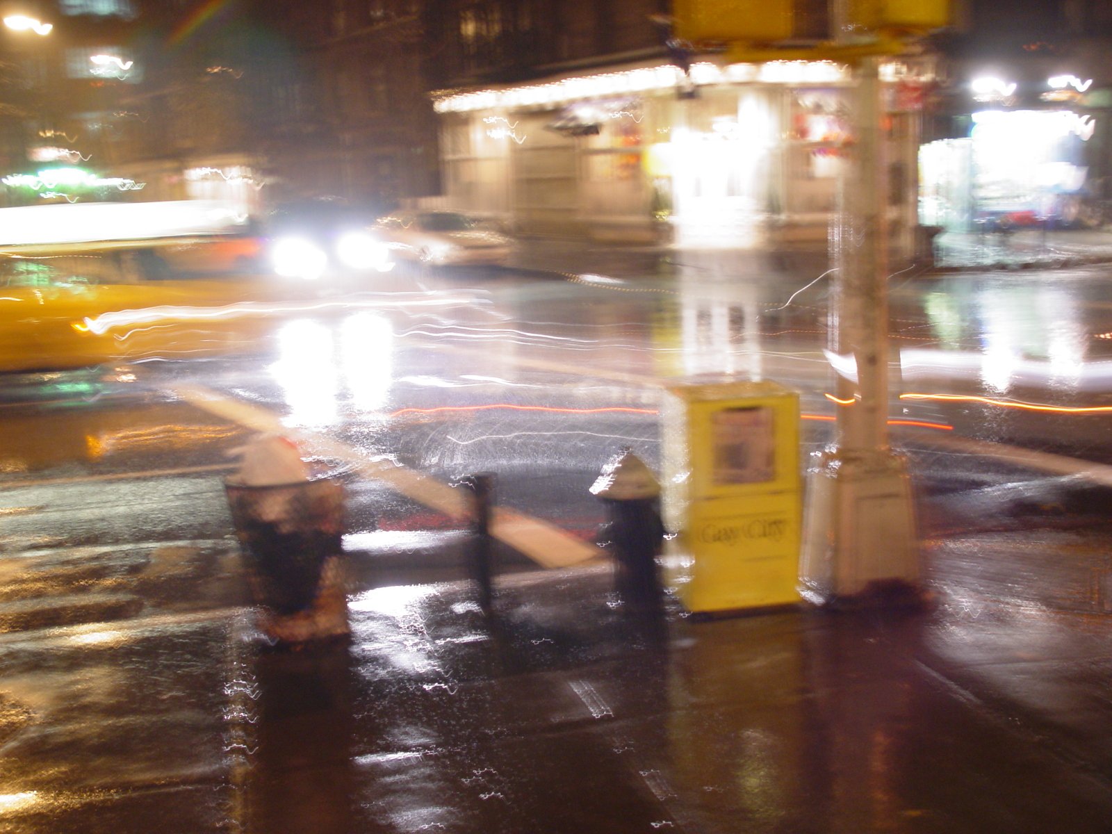 a view of an intersection with cars driving by