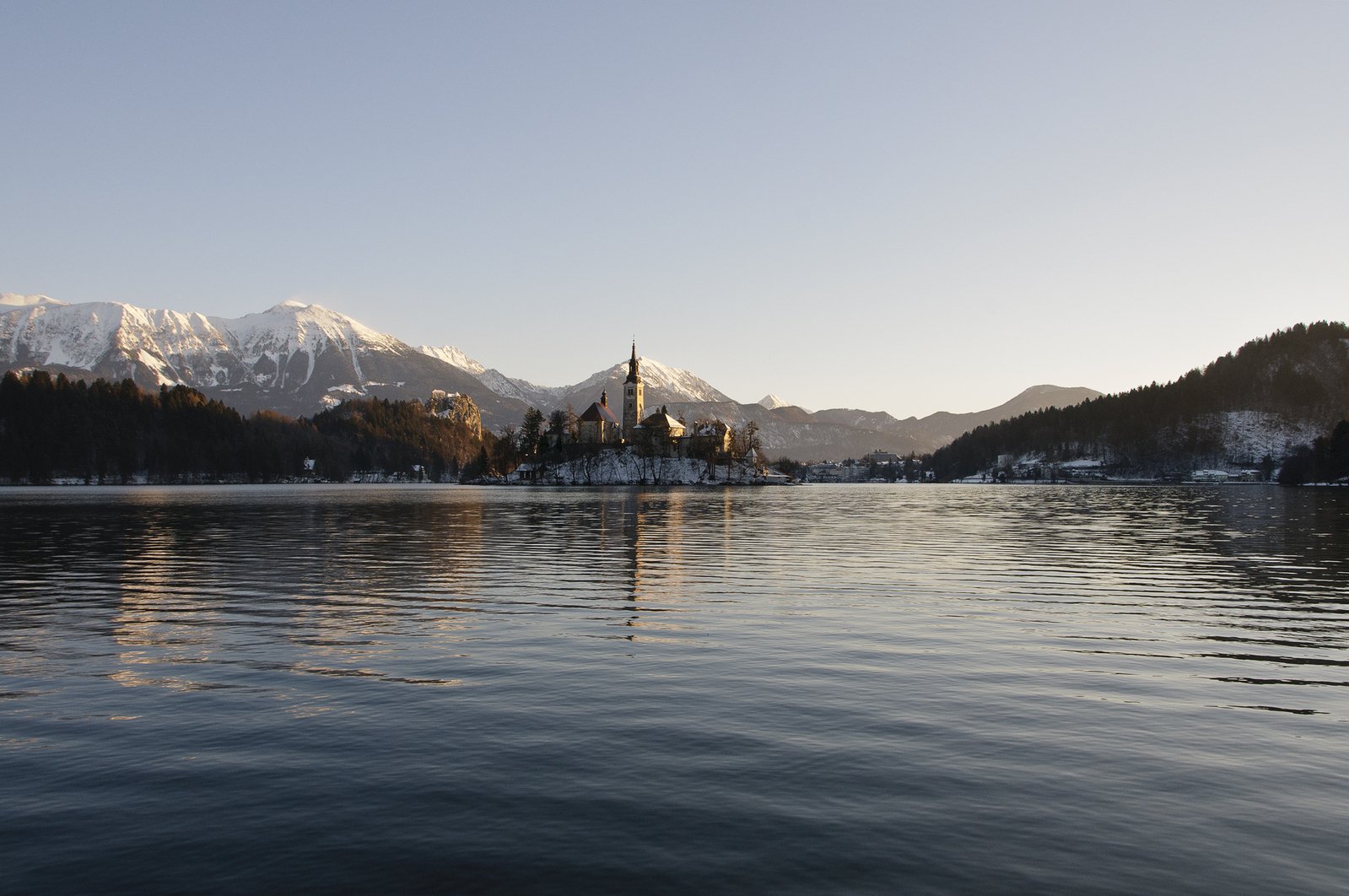 a lake in the middle of snowy mountains