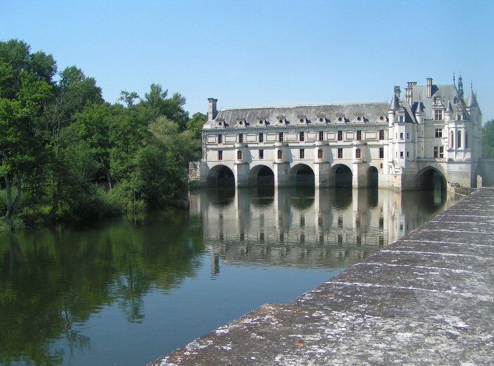 a picture of a large building on the side of the river