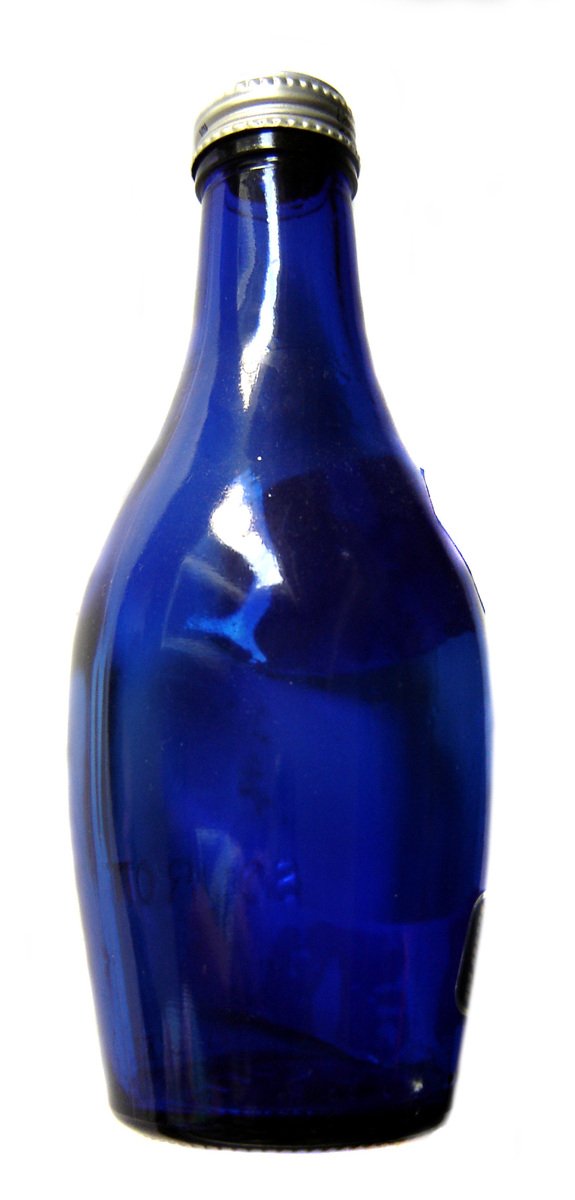 a blue glass bottle is shown on a white surface
