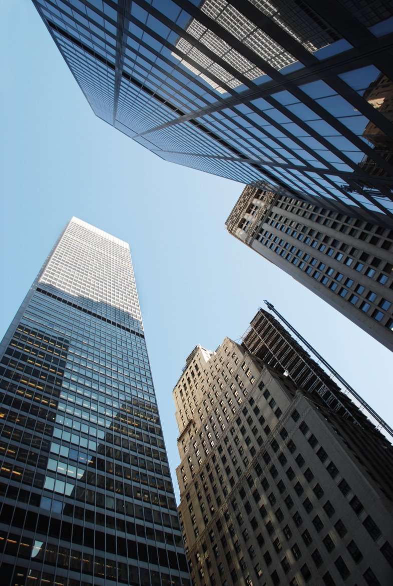 three tall buildings in the middle of a city