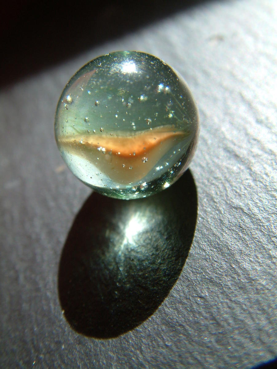 a small glass object with bubbles in it