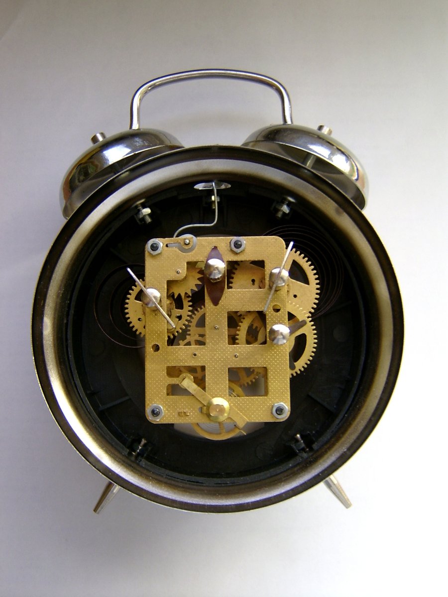 a clock in front of white backdrop showing the time
