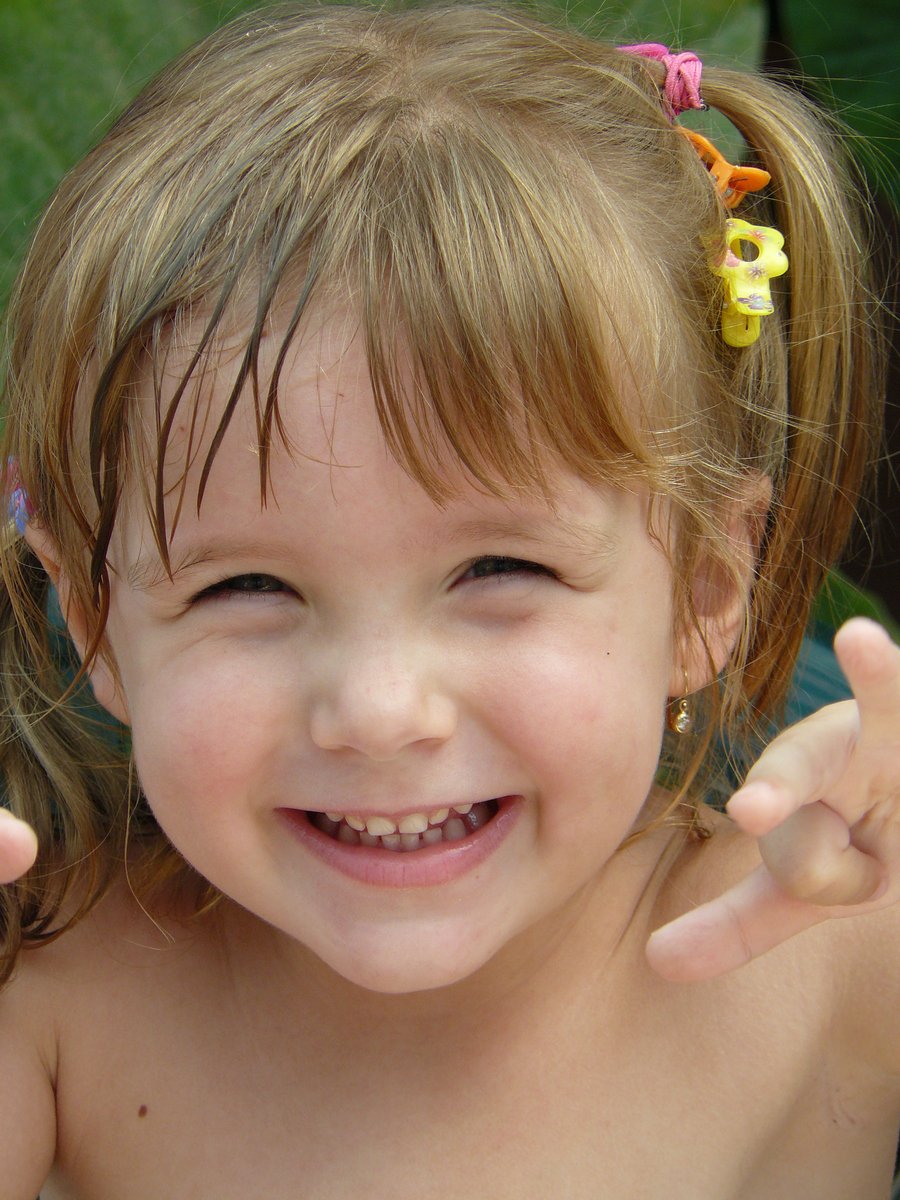 a close up of a child with a frisbee in her hand