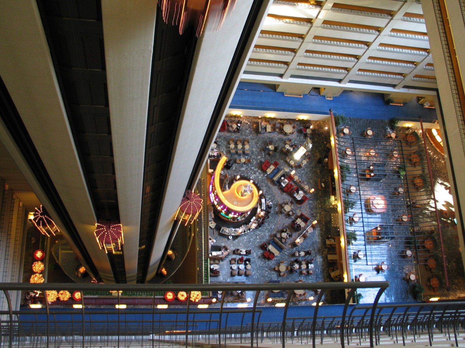 a huge atrium in an office building with lit up lights