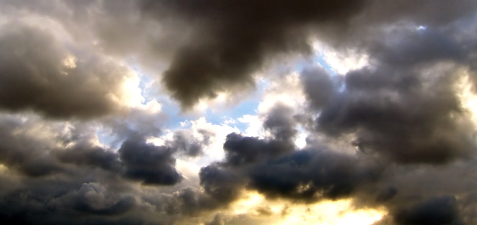 some clouds are above the ground on a sunny day