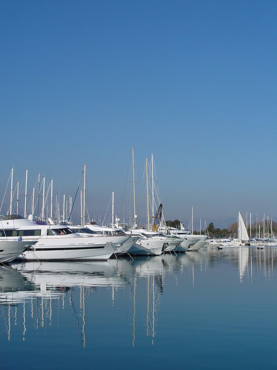 sailboats docked and in the water with bright blue skies